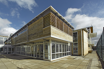 External view of full height glazing and timber cladding and timber louvres to John Cabot Academy 6th form centre