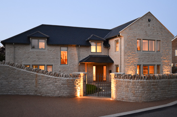 Image of the front of the new build Cotswold country house, designed by Hetreed Ross Architects.