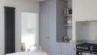 Image illustrating new kitchen space, large cupboards and plenty of storage arranged in a minimal way. 