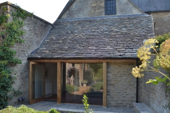 Image showing the oak and glass reworking of the ground floor exterior of this Georgian house, showing how the old blends with the new, opening up the back of the house and linking it to the garden.