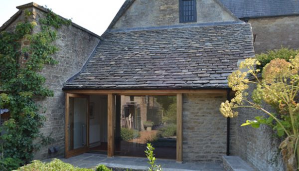 Image showing the oak and glass reworking of the ground floor exterior of this Georgian house, showing how the old blends with the new, opening up the back of the house and linking it to the garden.