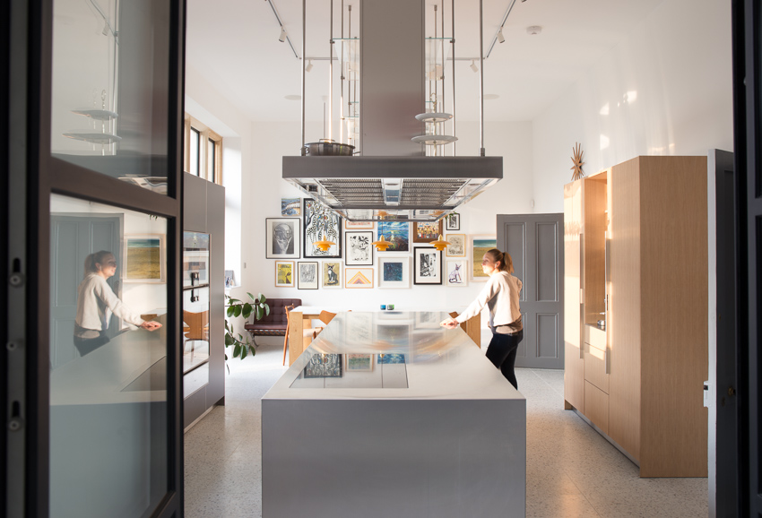 Internal photograph of the kitchen space, as a bright working environment with sleak lines and finishes.