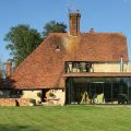Image showing medieval kent farmhouse with new glass and bronze kitchen extension