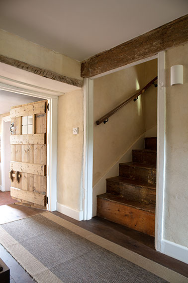 Image of hallway and natural timber staircase with exposed beam