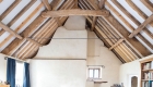 Image of eco refurbishment showing traditional exposed timber structure and render