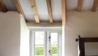 Image of a window and exposed timber structure and traditional flooring