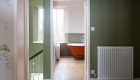 image of bathroom approach with green painted wall