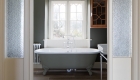Bathroom design with freestanding bath in grey colour