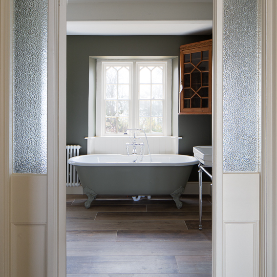 Bathroom design with freestanding bath in grey colour