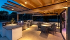Image of outdoor dining and kitchen/barbecue area with exposed timber structure canopy