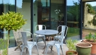 Metal chairs on external terrace outside new extension