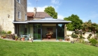 View elevation of contemporary extension with full height glazing and zinc pyramid roof