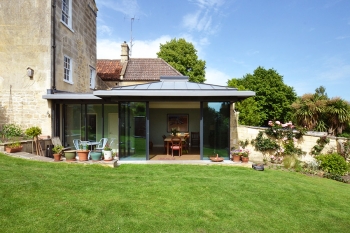 View elevation of contemporary extension with full height glazing and zinc pyramid roof