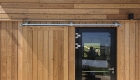 Sliding timber shutters in front of doors secure the building when not in use