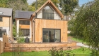 front view of new house with thimber cladding and roof terrace
