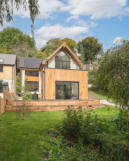 front view of new house with thimber cladding and roof terrace