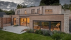 contemporary new cedar clad house at dusk