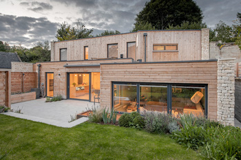 contemporary new cedar clad house at dusk