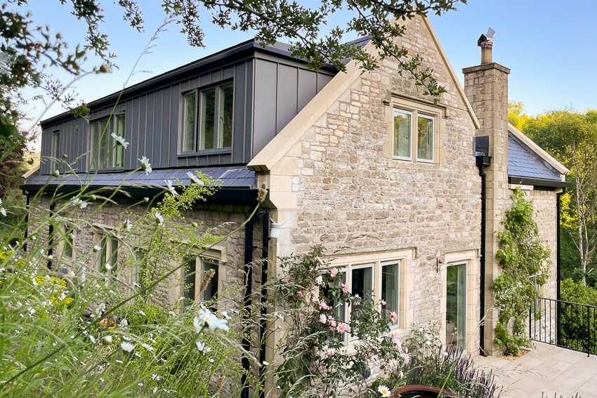 view of large zinc dormer on stone house