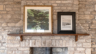 stone fireplace woodburner and paintings