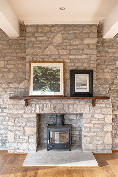 stone fireplace woodburner and paintings